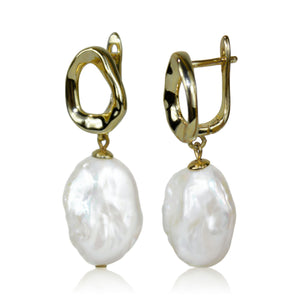 Gold hoop earrings with white pearls on a white background