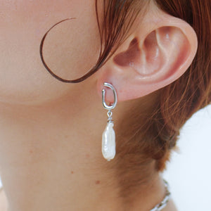 Model is wearing a pair of white pearl earrings with a curved design, displayed on a silver-tone latch-back clasp. Perfect for Christmas Gifts. 