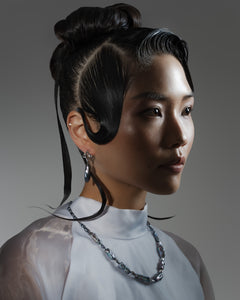 Model is wearing an elegant dark iridescent baroque pearl necklace and earrings set — timeless bridal and anniversary jewellery