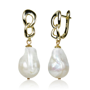 Gold chain earrings with white pearls on a white background