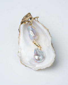 A pair of silver-colored baroque pearl earrings with gold-plated latch-back clasps, featuring a fireball design and sparkling cubic zirconia.