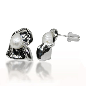 Pair of silver earrings with pearl-like centers on a white background